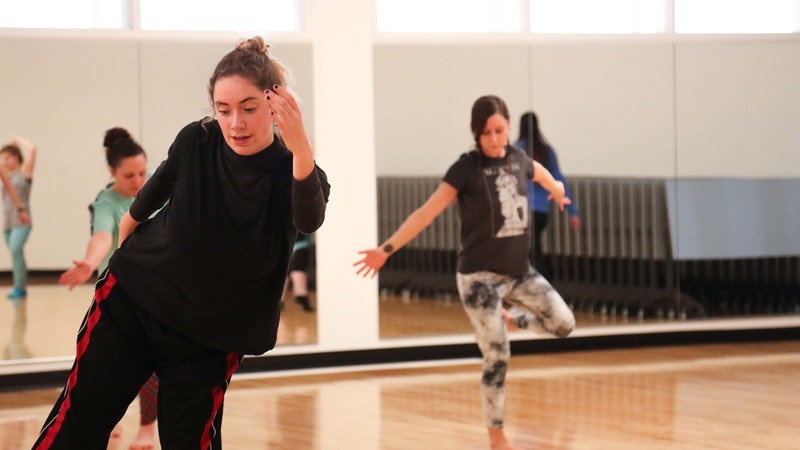 Students dancing in class with mirror background