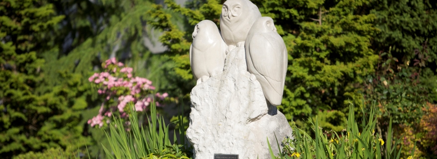 Owl statue with greenery