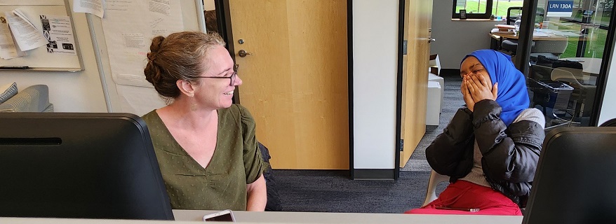 student and faculty in the Writing Center