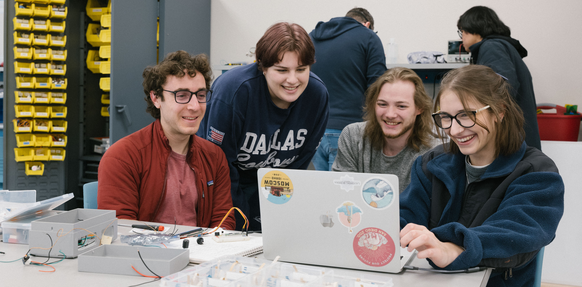 Three WCC engineering students doing work on their laptop