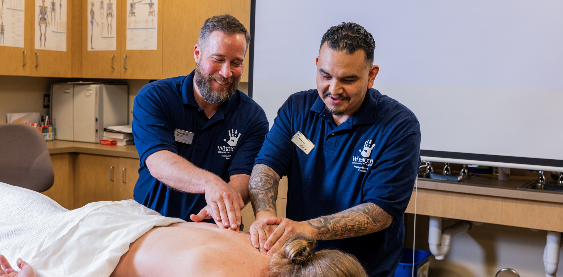 A WCC student and professor practicing massage skills on a student