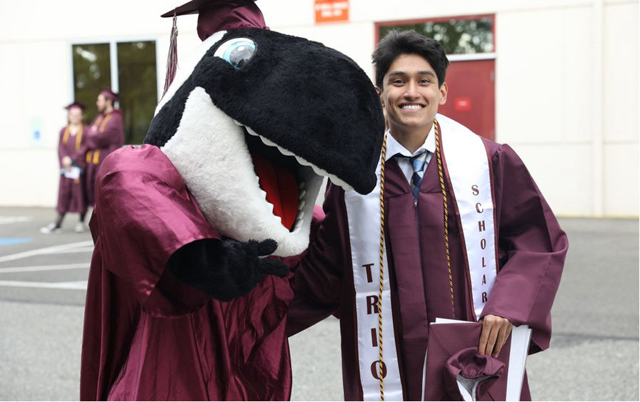 TRIO Student Graduate with Orca Mascot